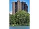 Striking high-rise with multiple balconies, adjacent to a lush park and serene lake for tranquil outdoor enjoyment at 460 S Marion Pkwy # 453, Denver, CO 80209