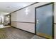 Hallway with carpet and wall lighting leading to an apartment entrance, plus a seating area at 460 S Marion Pkwy # 453, Denver, CO 80209