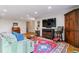 Comfortable living room with wood floors, a cozy couch, and a large television at 460 S Marion Pkwy # 453, Denver, CO 80209