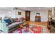 Inviting living room with wood floors, a comfortable couch, and decorative furnishings at 460 S Marion Pkwy # 453, Denver, CO 80209