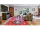 Open-concept living room with wood floors, a comfortable couch, and access to the balcony at 460 S Marion Pkwy # 453, Denver, CO 80209
