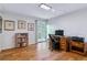 Bright home office with hardwood floors, a desk, and a sliding door to the outside at 460 S Marion Pkwy # 453, Denver, CO 80209