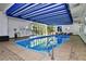 Bright indoor swimming pool area featuring a blue and white striped awning with garden views at 460 S Marion Pkwy # 453, Denver, CO 80209