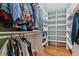 Spacious walk-in closet boasts custom shelving, hardwood floors, and ample storage for clothes and accessories at 460 S Marion Pkwy # 453, Denver, CO 80209
