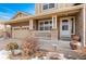 Front porch with stone pillars, railing, and a white door at 258 N Catawba Ct, Aurora, CO 80018