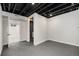 Unfinished basement area with dark ceiling and flooring at 6250 W 76Th Ave, Arvada, CO 80003