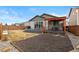 Wide shot of the backyard featuring grass, stone, mulch bed, tiered deck with pergola and a gray house at 9227 Englemann Ct, Parker, CO 80134