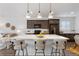 Bright kitchen with large island, pendant lighting, seating, and modern appliances at 9227 Englemann Ct, Parker, CO 80134