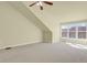 Bright bedroom features neutral walls, carpet, a ceiling fan, and large windows at 3223 Iron Forge Pl # 108, Boulder, CO 80301