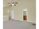 Spacious bedroom features neutral walls, carpet, ceiling fan, and an ensuite bathroom at 3223 Iron Forge Pl # 108, Boulder, CO 80301