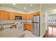 Efficient kitchen featuring stainless steel refrigerator and ample wood cabinets for storage and organization at 3223 Iron Forge Pl # 108, Boulder, CO 80301