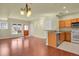 Open-concept living and kitchen area with hardwood floors, modern lighting, and functional layout at 3223 Iron Forge Pl # 108, Boulder, CO 80301