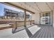 Spacious back porch featuring wood flooring and string lights, perfect for outdoor entertaining at 9772 Taylor River Cir, Littleton, CO 80125
