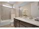 Well-lit bathroom featuring a tub/shower combo and double sink vanity at 9772 Taylor River Cir, Littleton, CO 80125