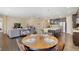Cozy dining area with hardwood floors and open layout connecting living room and kitchen at 9772 Taylor River Cir, Littleton, CO 80125