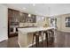 Modern kitchen with sleek countertops, stainless steel appliances, and a large island with bar seating at 9772 Taylor River Cir, Littleton, CO 80125