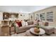 Bright and airy living room featuring a comfortable sectional sofa and large windows with natural light at 9772 Taylor River Cir, Littleton, CO 80125