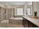 Luxurious main bathroom with a walk-in shower, soaking tub, and double vanity at 9772 Taylor River Cir, Littleton, CO 80125