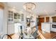 Eat-in kitchen with glass table, black chairs, and white cabinetry at 16504 E Dorado Ave, Centennial, CO 80015