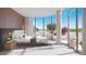 Serene main bedroom with curved windows, natural light, modern furnishings, and a private balcony at 185 Steele St # 503, Denver, CO 80206