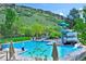 Resort-style pool with waterslide and plenty of lounge chairs at 13 Canyon Cedar, Littleton, CO 80127