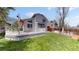 Large backyard features deck area and lush green lawn, great for outdoor activities at 2330 Redwood Ave, Lafayette, CO 80026