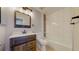 Modern bathroom features a new vanity and a shower-tub combination with updated tile at 2330 Redwood Ave, Lafayette, CO 80026