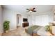 Bright bedroom features a ceiling fan, mounted TV, and large closet with ample natural light at 2330 Redwood Ave, Lafayette, CO 80026
