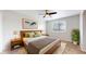Serene bedroom with a large window, a king-sized bed, natural wood furniture, and warm, inviting colors at 2330 Redwood Ave, Lafayette, CO 80026