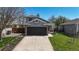 Charming two-story home with a gray exterior, a well-manicured lawn, and a two-car garage with a concrete driveway at 2330 Redwood Ave, Lafayette, CO 80026