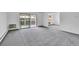 Spacious living room offers a sliding glass door and comfortable gray carpeting at 9655 E Center Ave # 9D, Denver, CO 80247