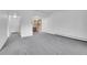 Open-concept living area with gray carpet flowing into the adjacent kitchen at 9655 E Center Ave # 9D, Denver, CO 80247