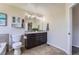 Bathroom featuring double sinks, tiled floors, modern fixtures, and a separate toilet area for added privacy at 25097 E Lake Dr, Aurora, CO 80016