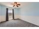 Simple bedroom with pale blue walls, white beadboard wainscoting, one window with gray curtains, and gray carpet at 25097 E Lake Dr, Aurora, CO 80016