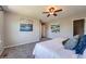 Bedroom featuring plush carpeting, art, and a ceiling fan offering comfort and style at 25097 E Lake Dr, Aurora, CO 80016