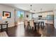 Dining area featuring white kitchen cabinets, an island, and sliding glass doors with backyard views at 25097 E Lake Dr, Aurora, CO 80016