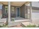 A cozy front porch featuring a brick facade and comfortable seating at 25097 E Lake Dr, Aurora, CO 80016
