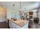 Open floor plan kitchen with kitchen island, stainless steel appliances and hardwood flooring at 25097 E Lake Dr, Aurora, CO 80016