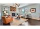 A bright living room with a stone fireplace, a ceiling fan, and hardwood floors at 25097 E Lake Dr, Aurora, CO 80016