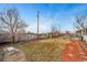 Sprawling backyard with a patio, pergola, fireplace, and lush lawn at 21600 E 11Th Ave, Aurora, CO 80018