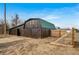 Barn with large doors and fenced area on a spacious lot, great for storage and recreational activities at 21600 E 11Th Ave, Aurora, CO 80018