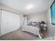 This bedroom features a bed, closet, carpet, and a lamp on a glass table at 21600 E 11Th Ave, Aurora, CO 80018