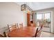 Dining room with a large wooden table, stylish lighting, and sliding glass doors leading to a deck, blending indoor and outdoor living at 21600 E 11Th Ave, Aurora, CO 80018