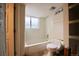 Small bathroom with a bathtub, toilet, and shelving at 8477 W 79Th Pl, Arvada, CO 80005