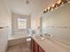 Full bathroom with tub, window, toilet, and sink with wood cabinets at 246 Rockview Dr, Superior, CO 80027