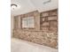 Basement room with stone and wood paneled wall, complete with built-in shelving at 1005 S Miller Way, Lakewood, CO 80226