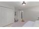 Neutral bedroom with a closet, chair, and an open doorway to the stairwell at 1005 S Miller Way, Lakewood, CO 80226