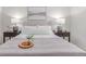 Bright bedroom featuring a comfortable bed with bedside tables and matching lamps at 1005 S Miller Way, Lakewood, CO 80226