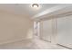 Bedroom with carpet, standard closet, and stairs visible through doorway at 1005 S Miller Way, Lakewood, CO 80226