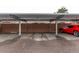 Carport parking area with designated spaces and a red car visible on the side at 1005 S Miller Way, Lakewood, CO 80226